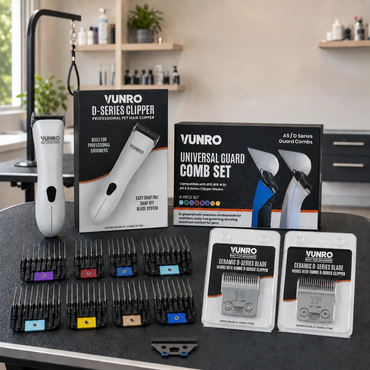VUNRO D Series Ready To Groom Clipper Kit contents on a grooming table with clipper, boxes, 8 guard combs and blades